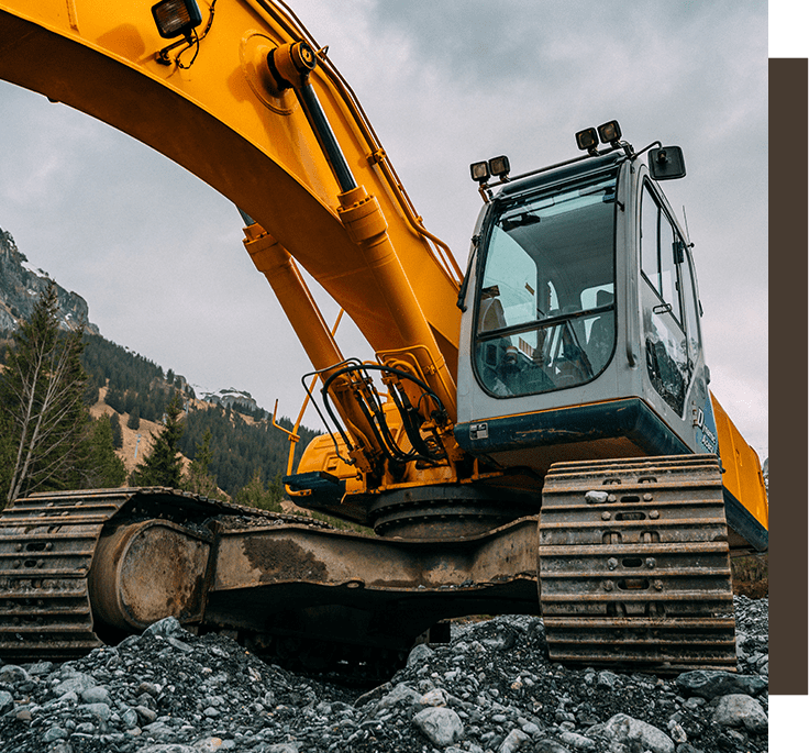 A yellow and black excavator is on the ground