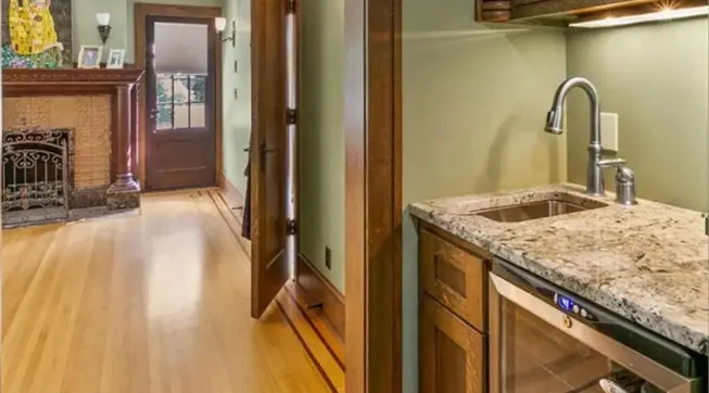 A kitchen with wooden floors and cabinets