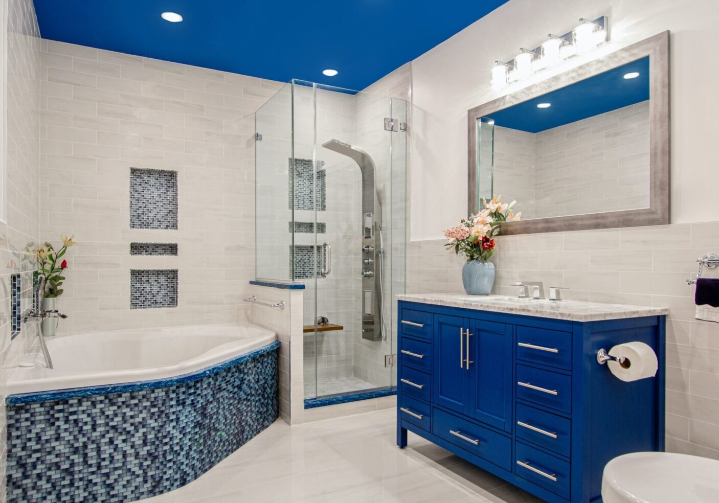 A bathroom with blue walls and white tile floors.