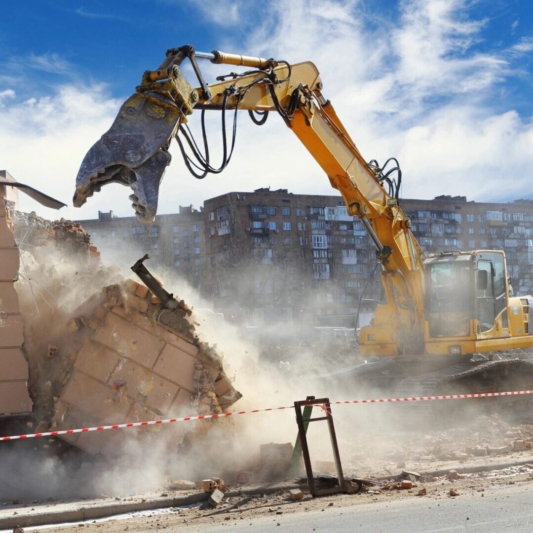 A yellow and black excavator is on the road