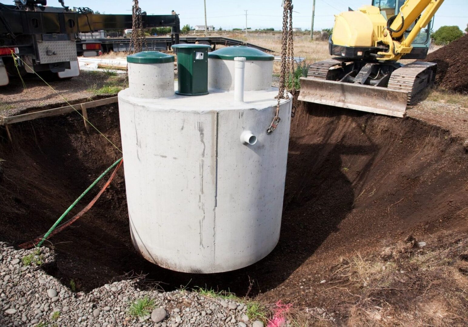 A white tank sitting in the middle of a dirt field.